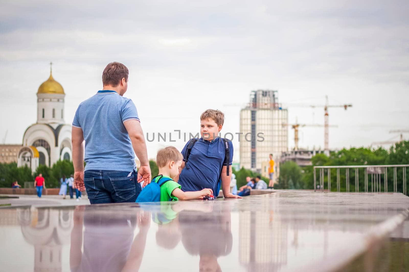 Portrait of a child, a boy against the backdrop of urban landscapes of skyscrapers and high-rise buildings in the open air. Children, Travel. Lifestyle in the city. Center, streets. by Alina_Lebed