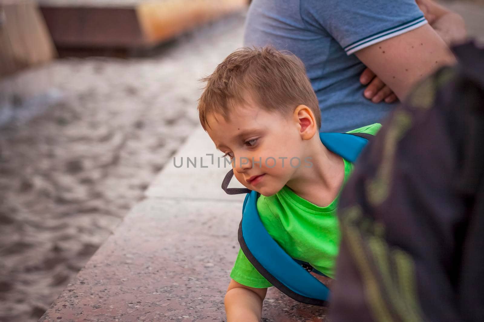 Portrait of a child, a boy against the backdrop of urban landscapes of skyscrapers and high-rise buildings in the open air. Children, Travel. Lifestyle in the city. Center, streets. Summer, a walk.