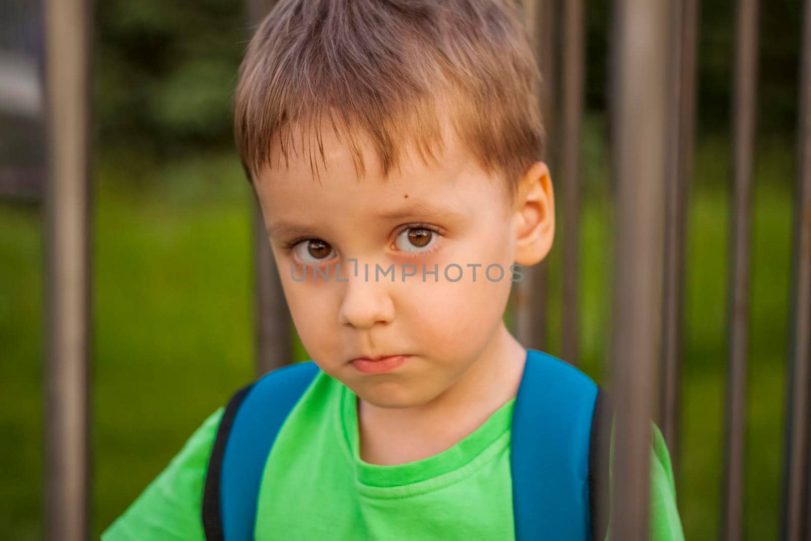 Portrait of a child, a boy against the backdrop of urban landscapes of skyscrapers and high-rise buildings in the open air. Children, Travel. Lifestyle in the city. Center, streets. Summer, a walk.