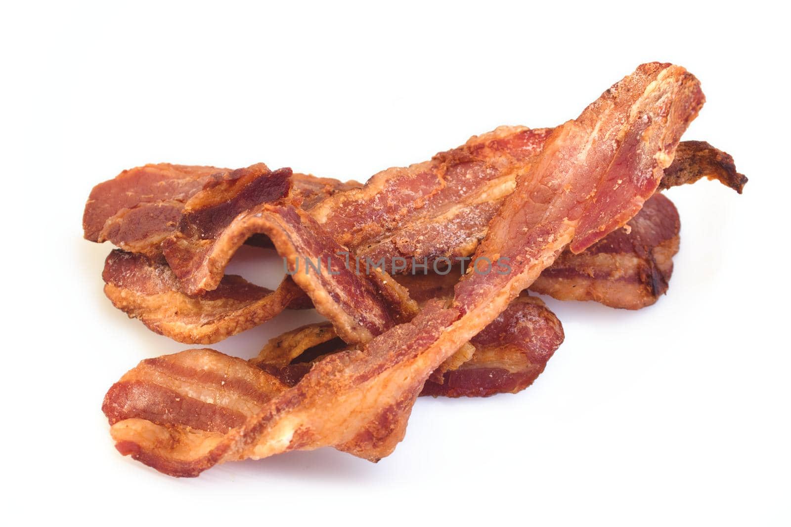 Crispy bacon rashers isolated against a white background