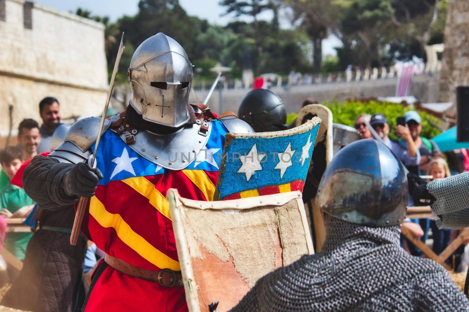 Mdina / Malta - May 4 2019: Men dressed as knights in armor reenacting a battle at a medieval festival by tennesseewitney