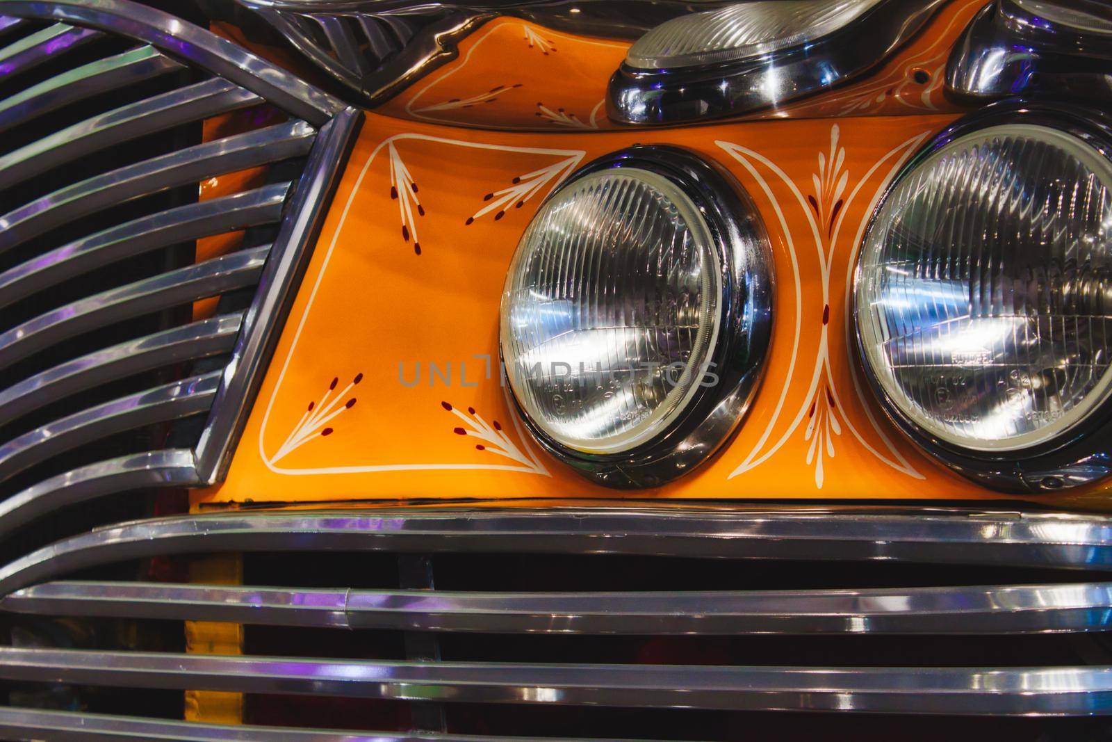 Close-up details of a vintage Maltese bus with headlamps and grill