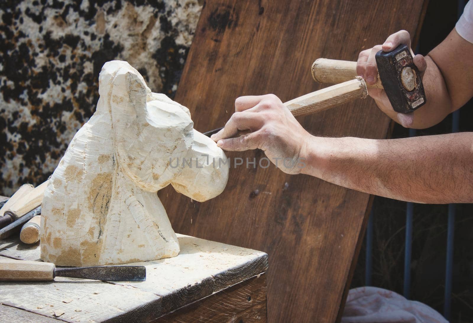 A stonemason carving a statue of a horse's head by tennesseewitney