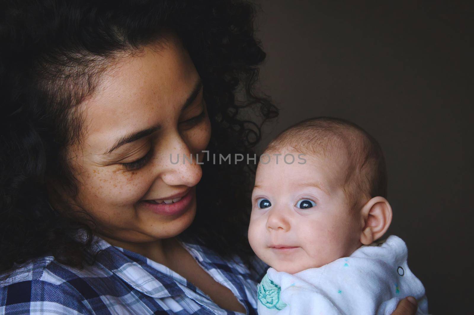 Happy smiling young mother with newborn baby by tennesseewitney