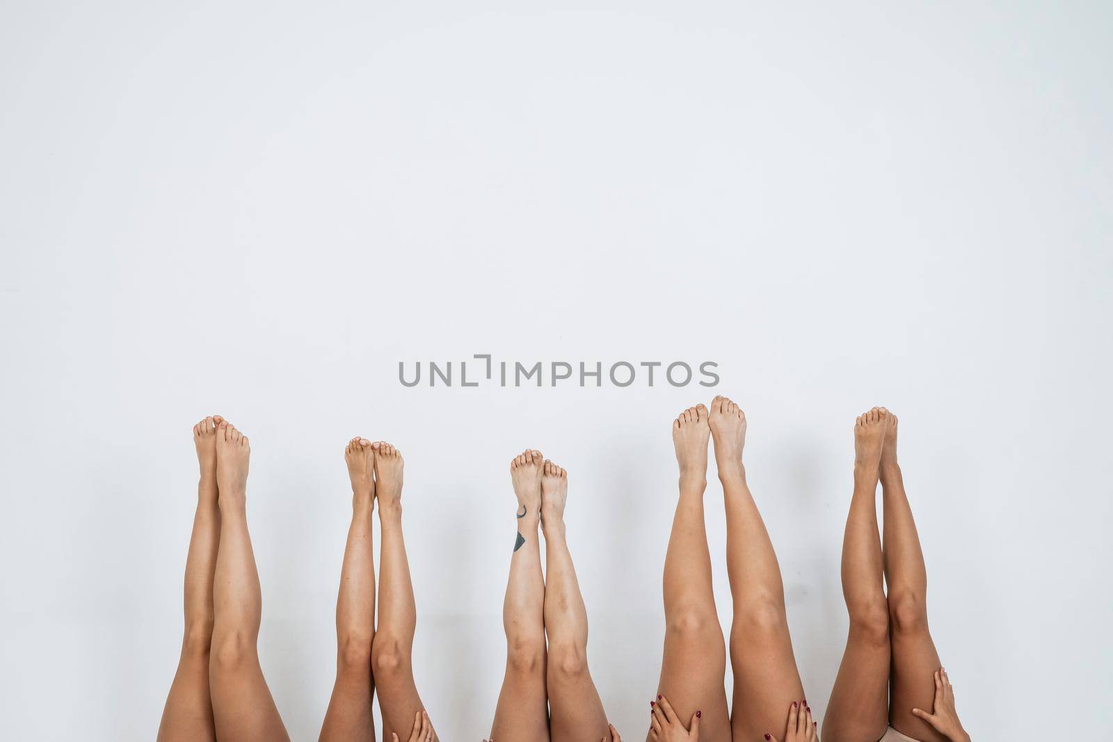 Sexy woman legs pointing up over white background