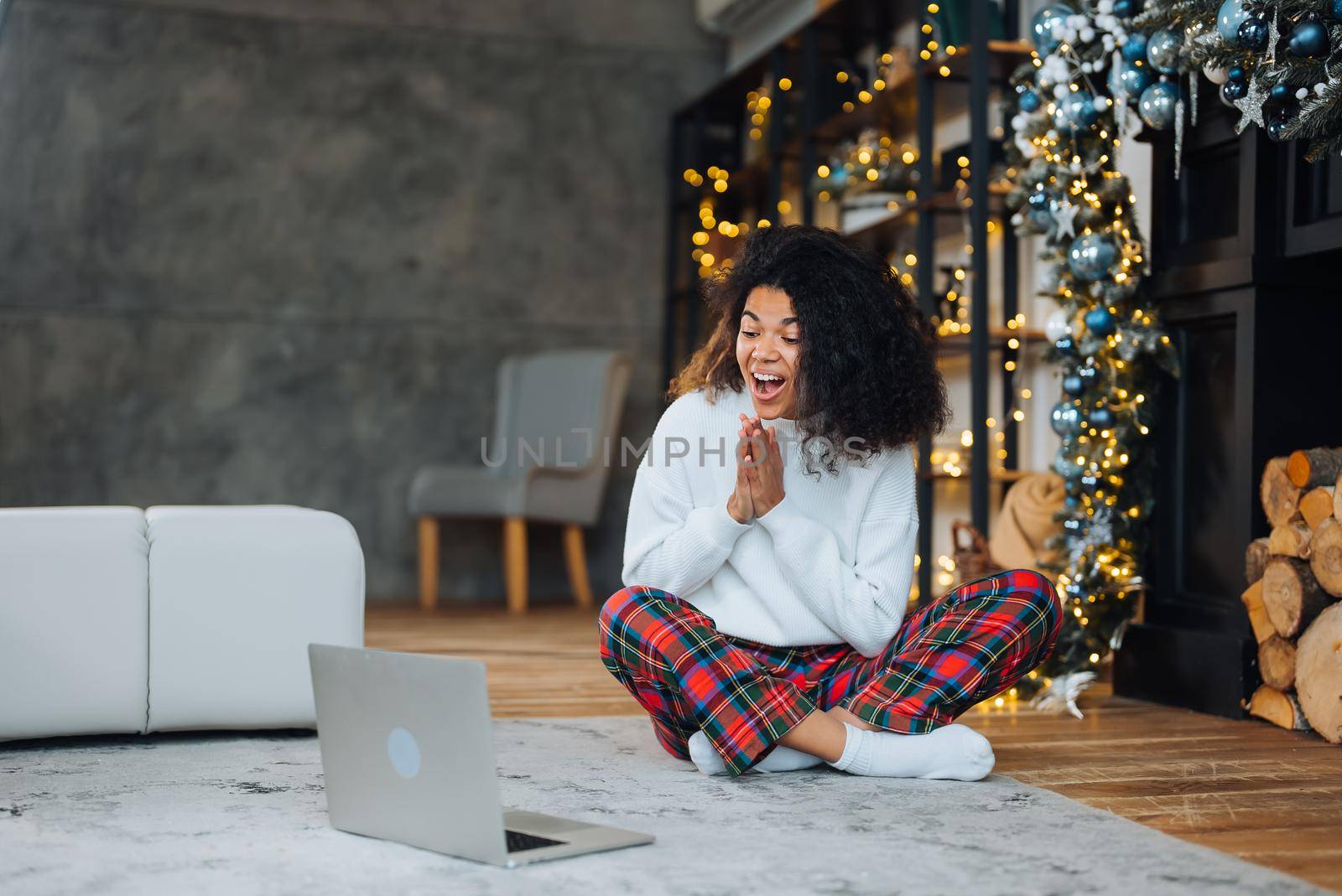 Beautiful young african american woman on the floor happy face smiling and looking at the camera. Positive person.