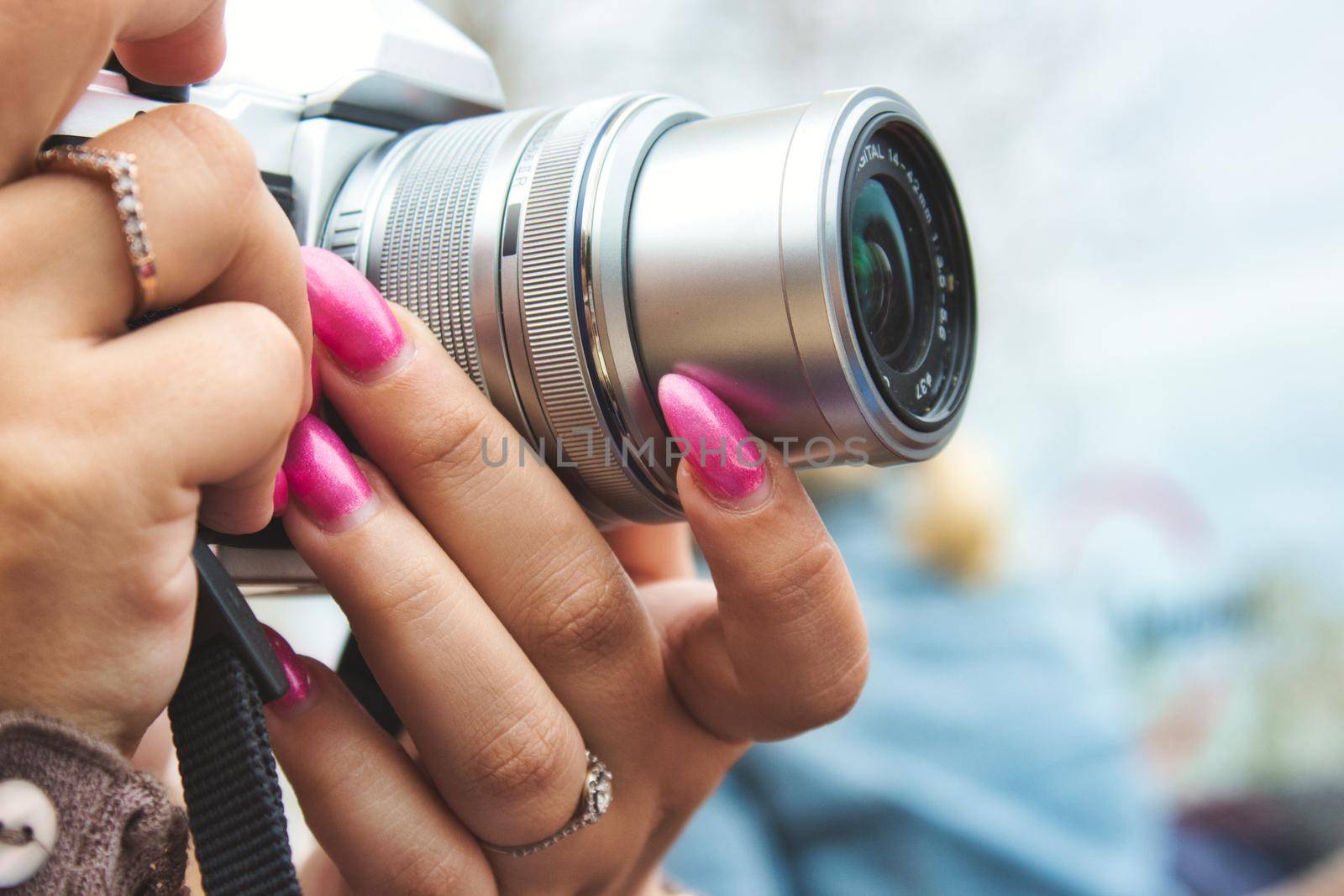 Close-up of a digital camera being used by a woman with painted fingernails by tennesseewitney
