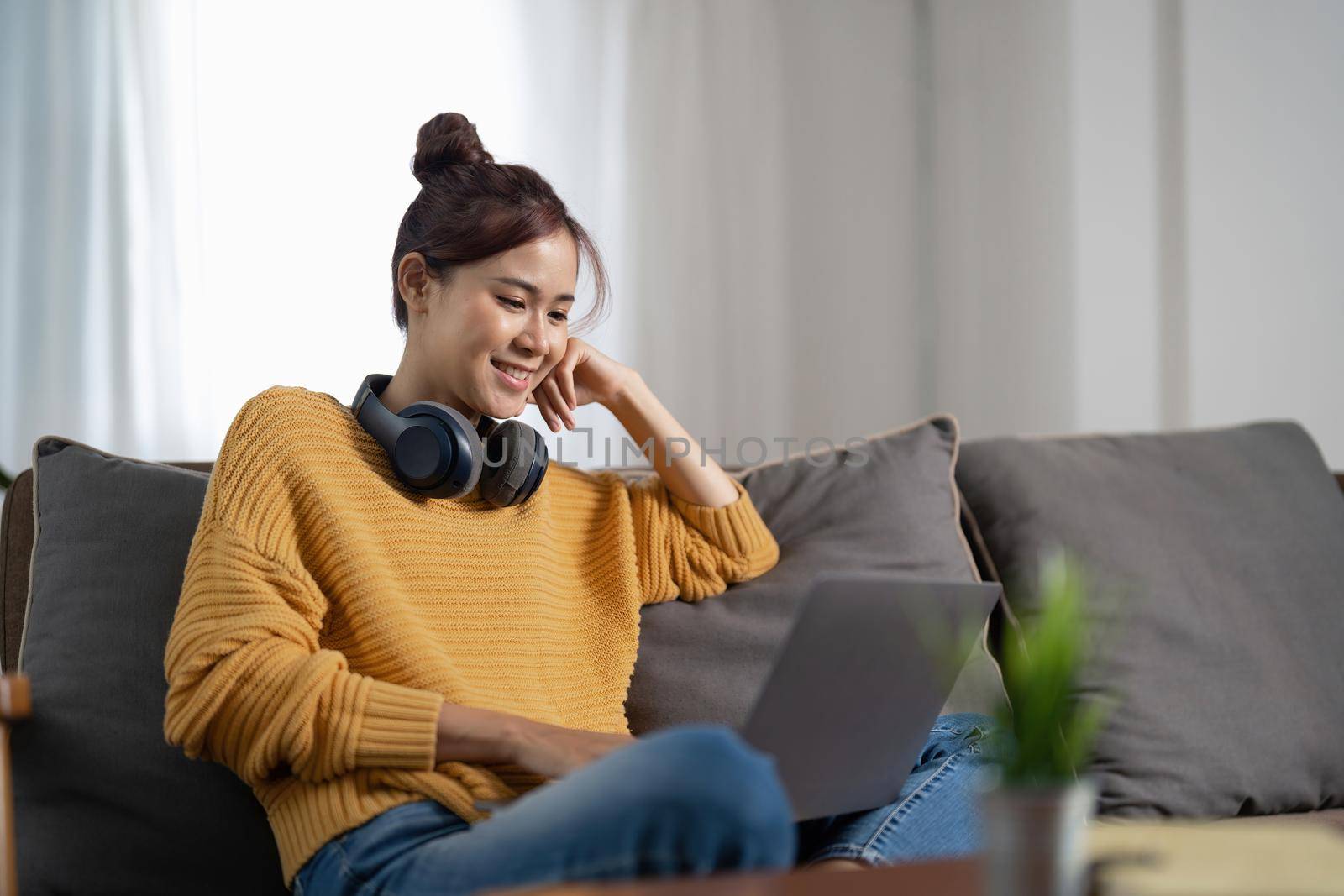 Young asian woman having conversation chatting while using laptop at house. Work at home, Video conference, Online meeting video call, Virtual meetings, Remote learning and E-learning