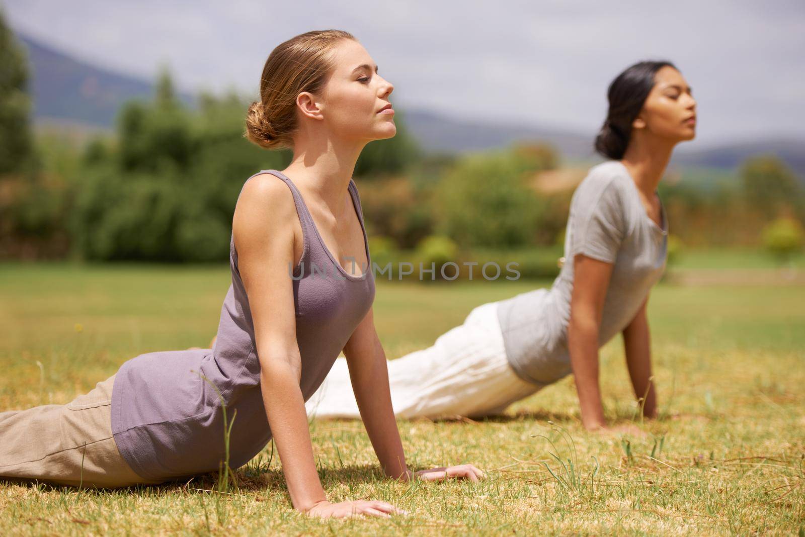 Women doing yoga outdoors.