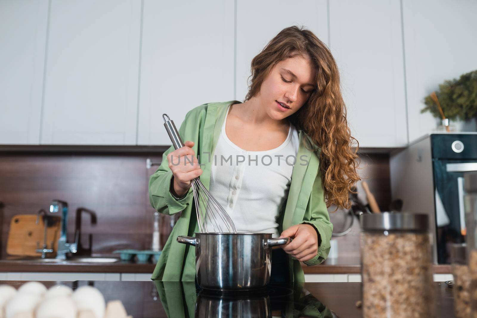 Woman is preparing food in the kitchen. Cooking At Home. Prepare Food.