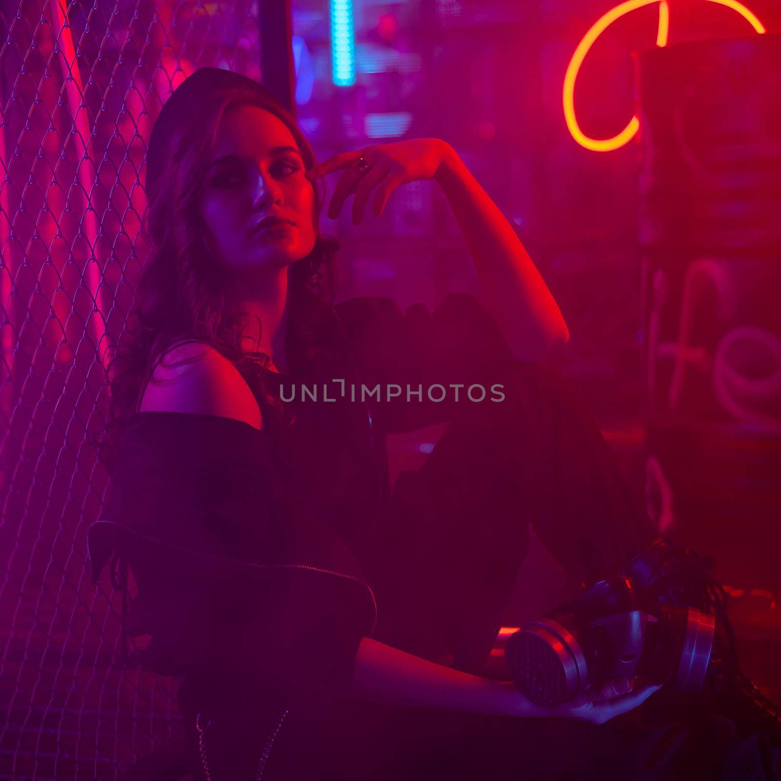 Caucasian woman posing in fog in neon studio