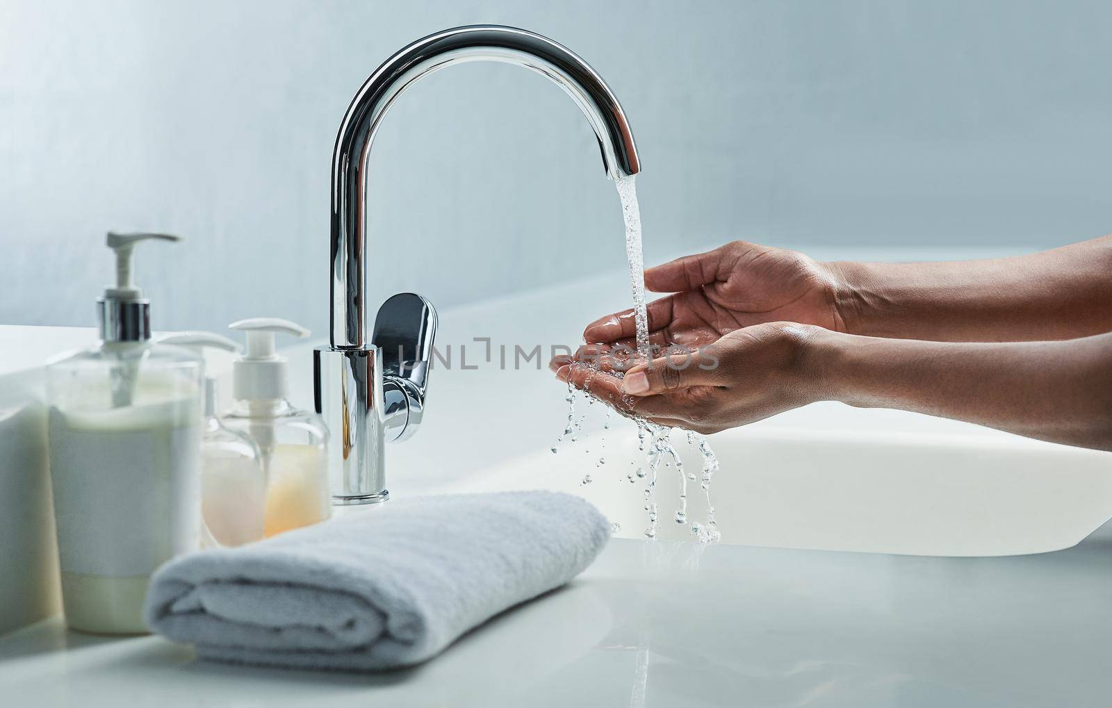 Germs and bacteria down the drain. Cropped shot of a man washing his hands in a bathroom sink. by YuriArcurs