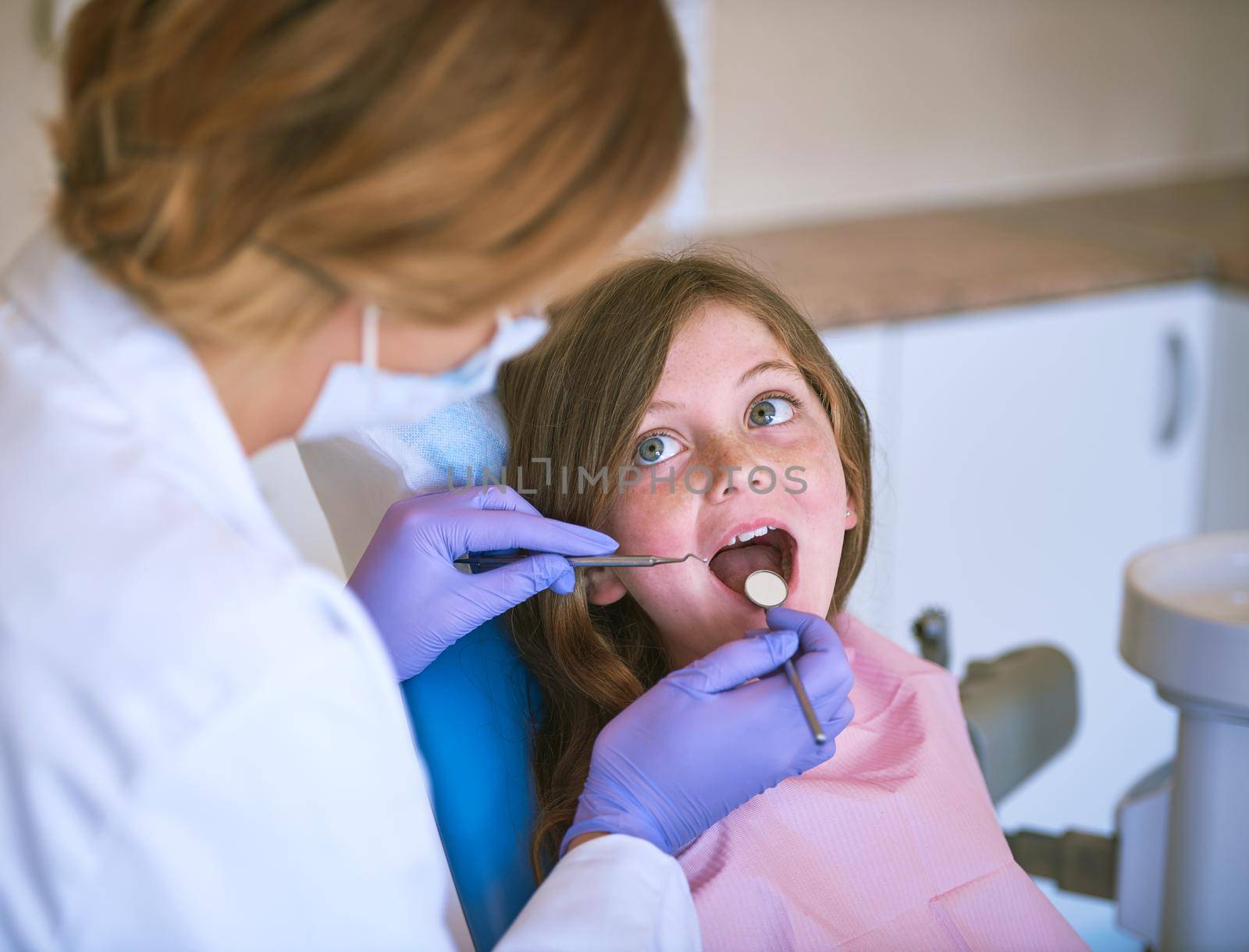 Cropped shot of a dentist examining a little girls teeth.