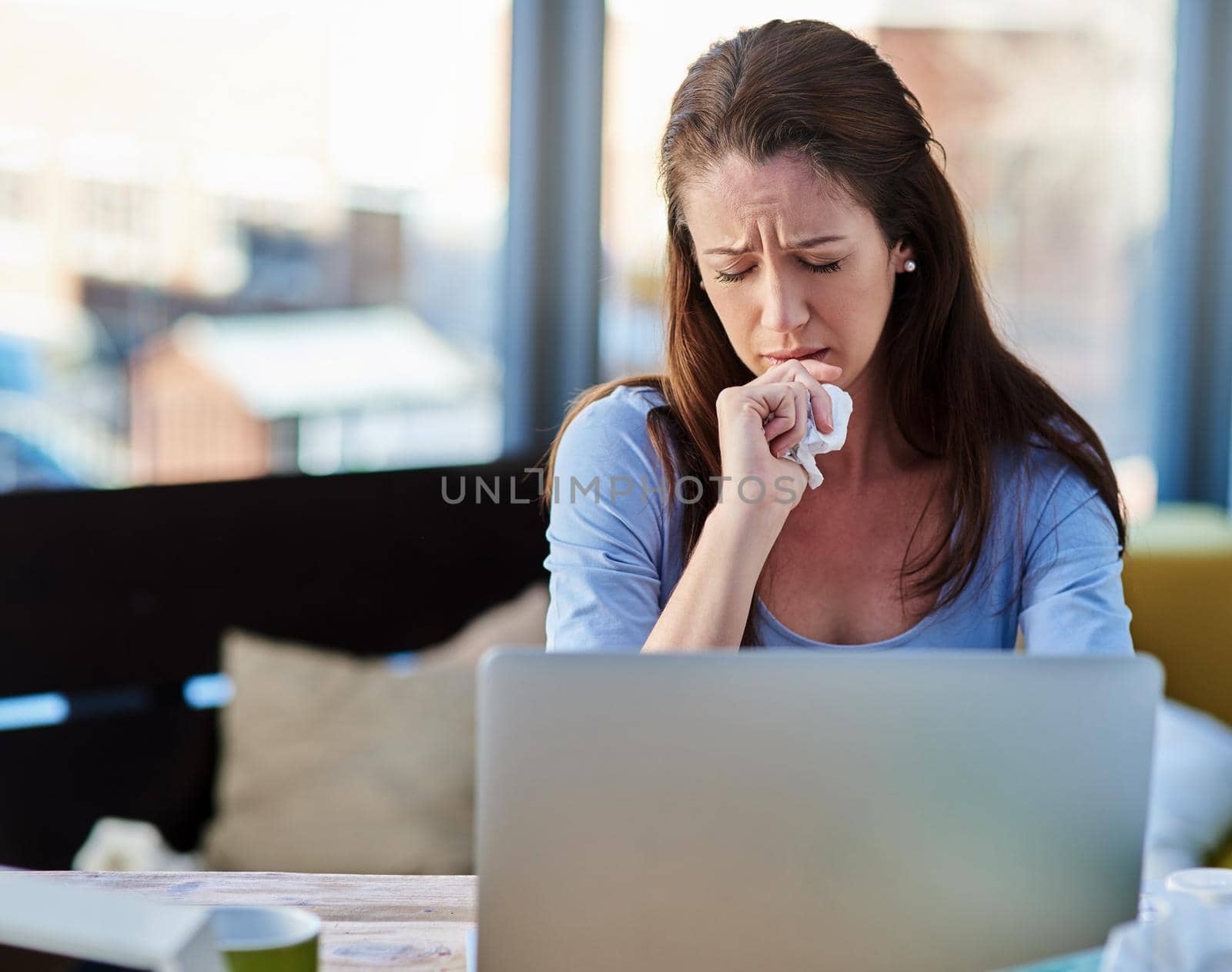 Sick with a stuffy nose. Cropped shot of a young woman feeling unwell at home. by YuriArcurs