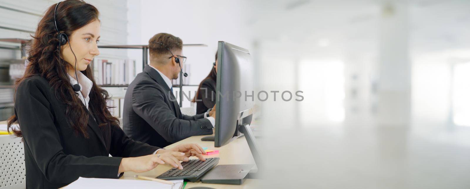 Business people wearing headset working in office broaden view by biancoblue