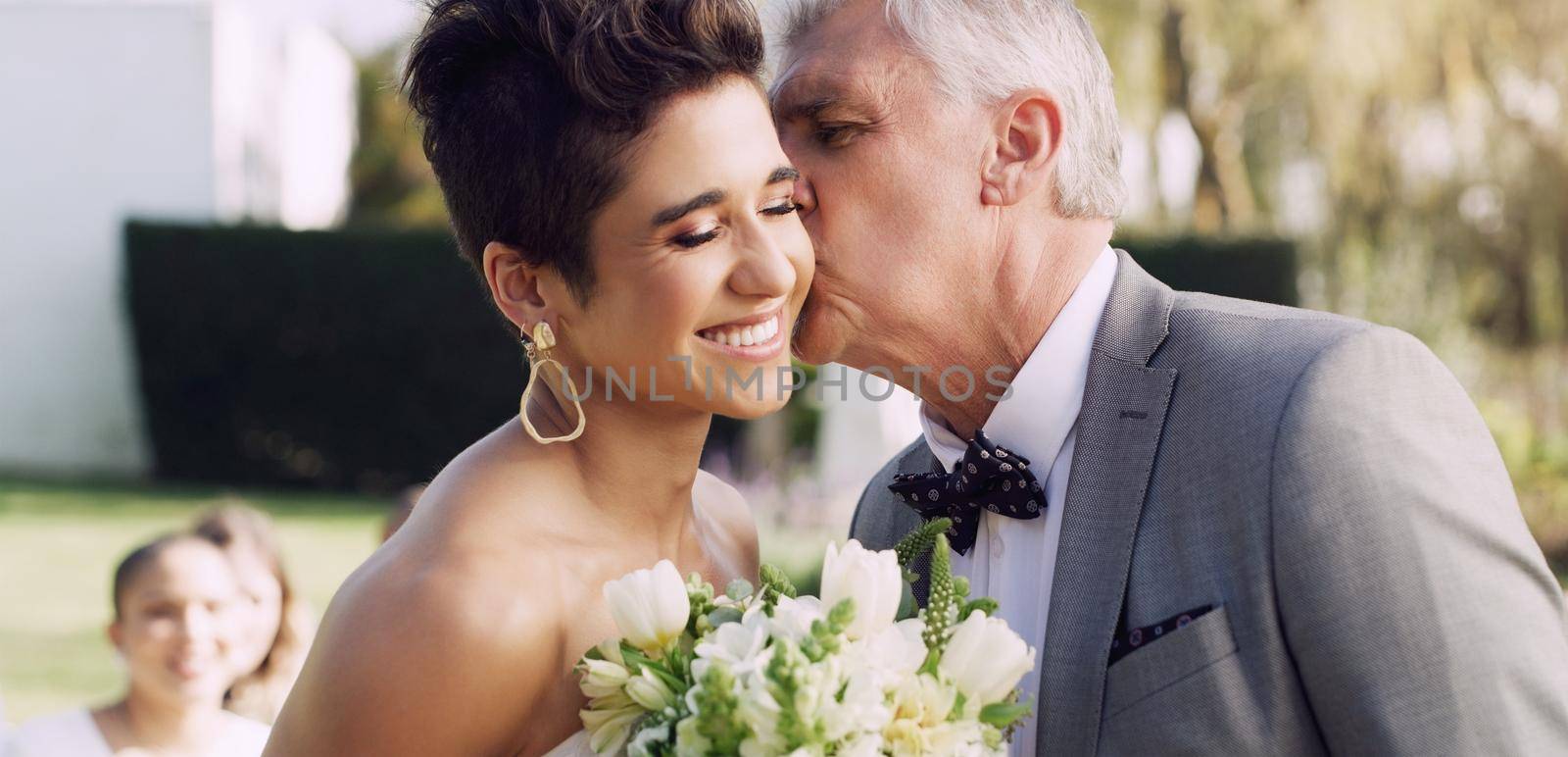 I couldnt be happier for you my angel. Cropped shot of an affectionate mature father kissing his daughter on the cheek on her wedding day. by YuriArcurs