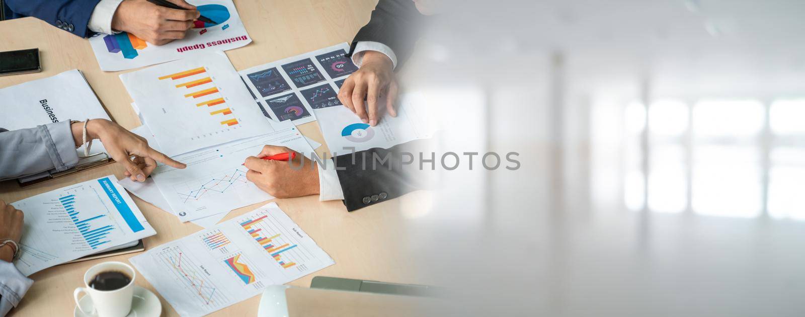 Smart businessman and businesswoman talking discussion in widen group meeting at office table in a modern office interior. Business collaboration strategic planning and brainstorming of coworkers.