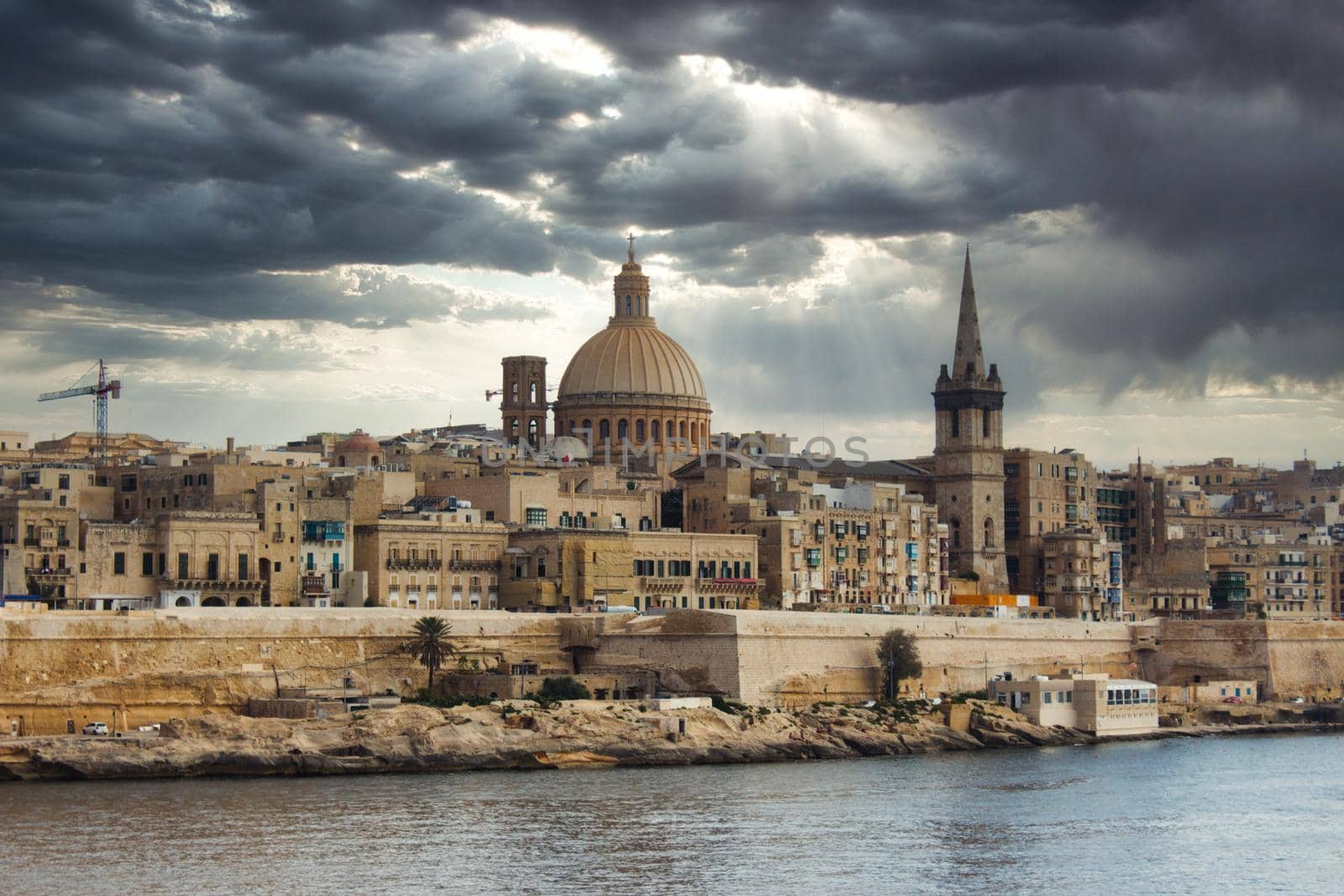Valletta city skyline with a moody dramatic sky in the background by tennesseewitney