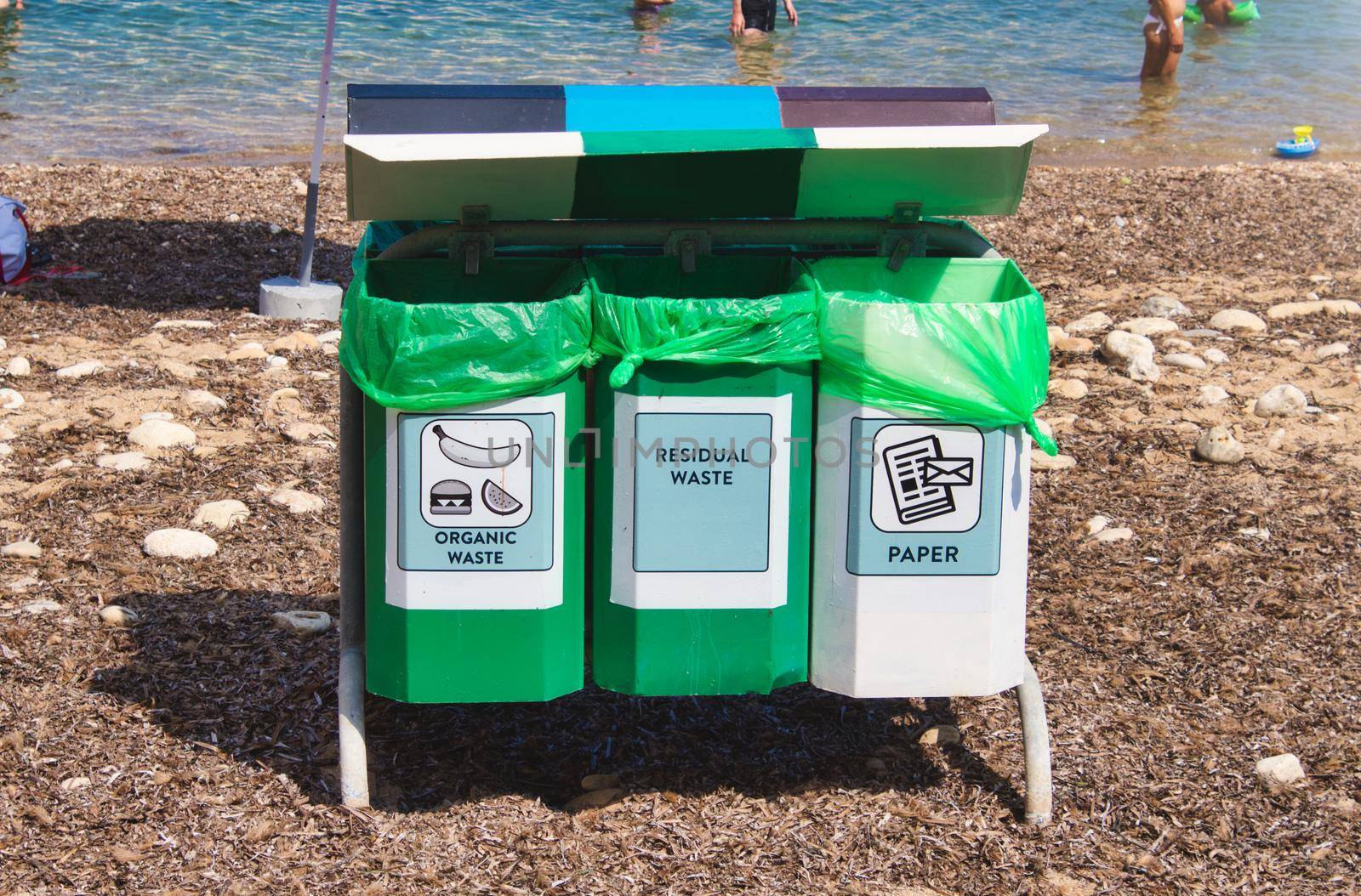 Recycling bins on a public natural beach