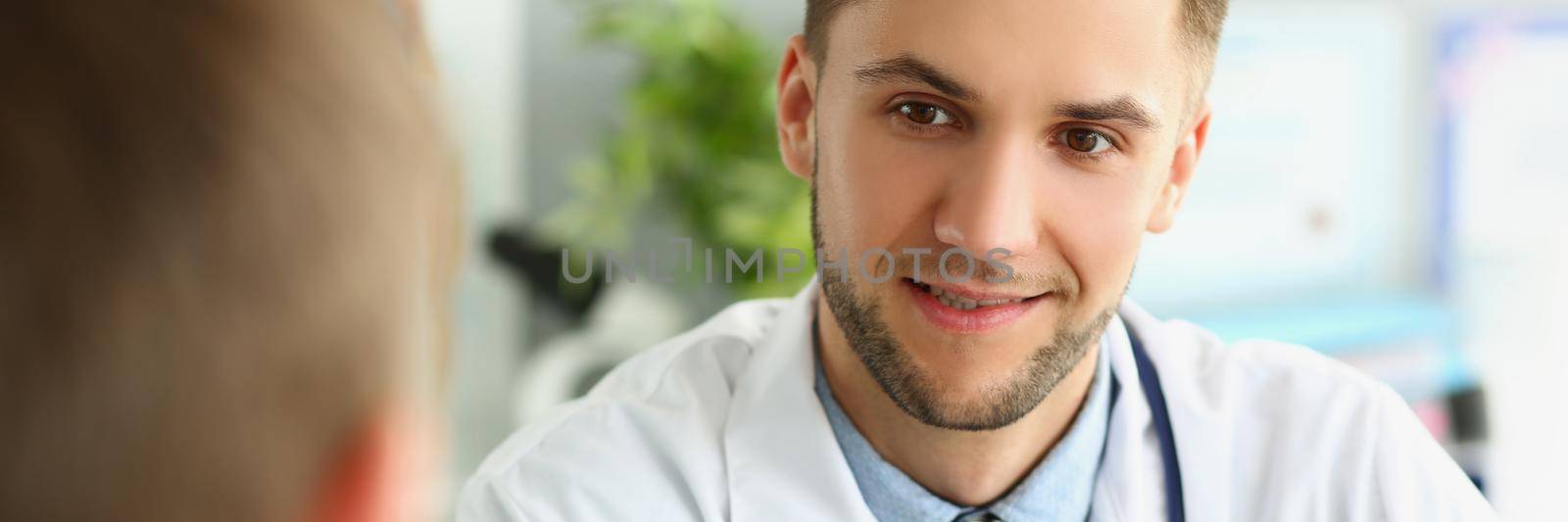 Male doctor listens to the patient, close-up face.Consultation in the clinic, patient complaints. Family medicine