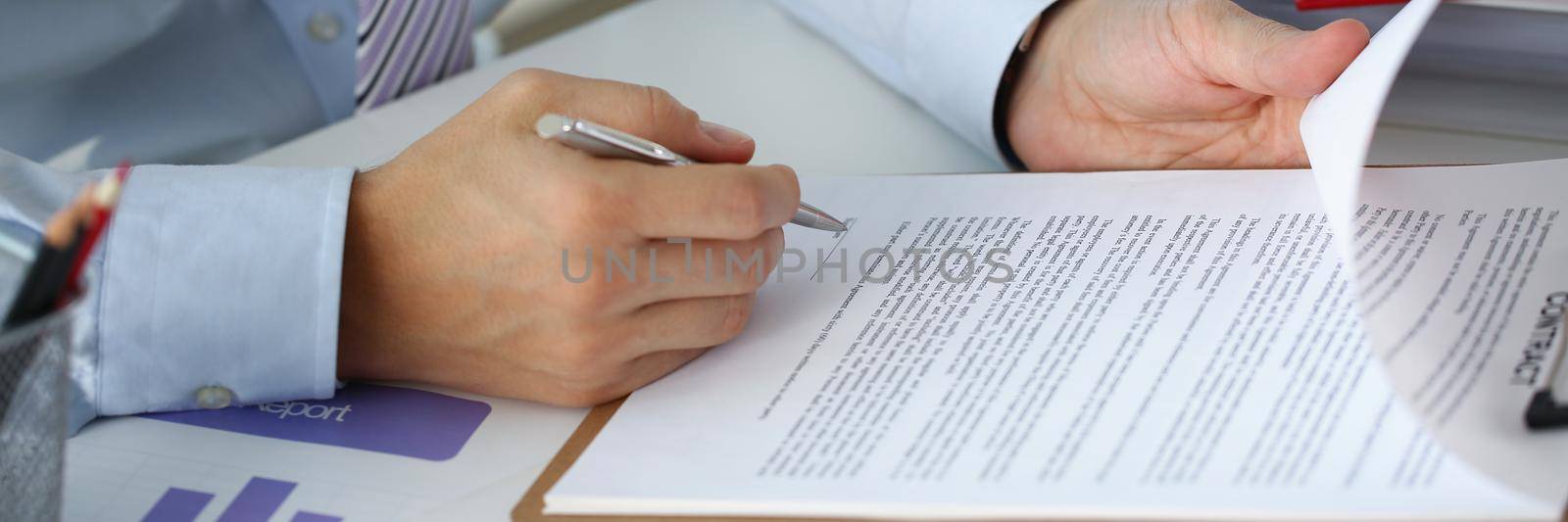 A man in the office signs a contract, close-up. Employment contract, company cooperation, proposal research