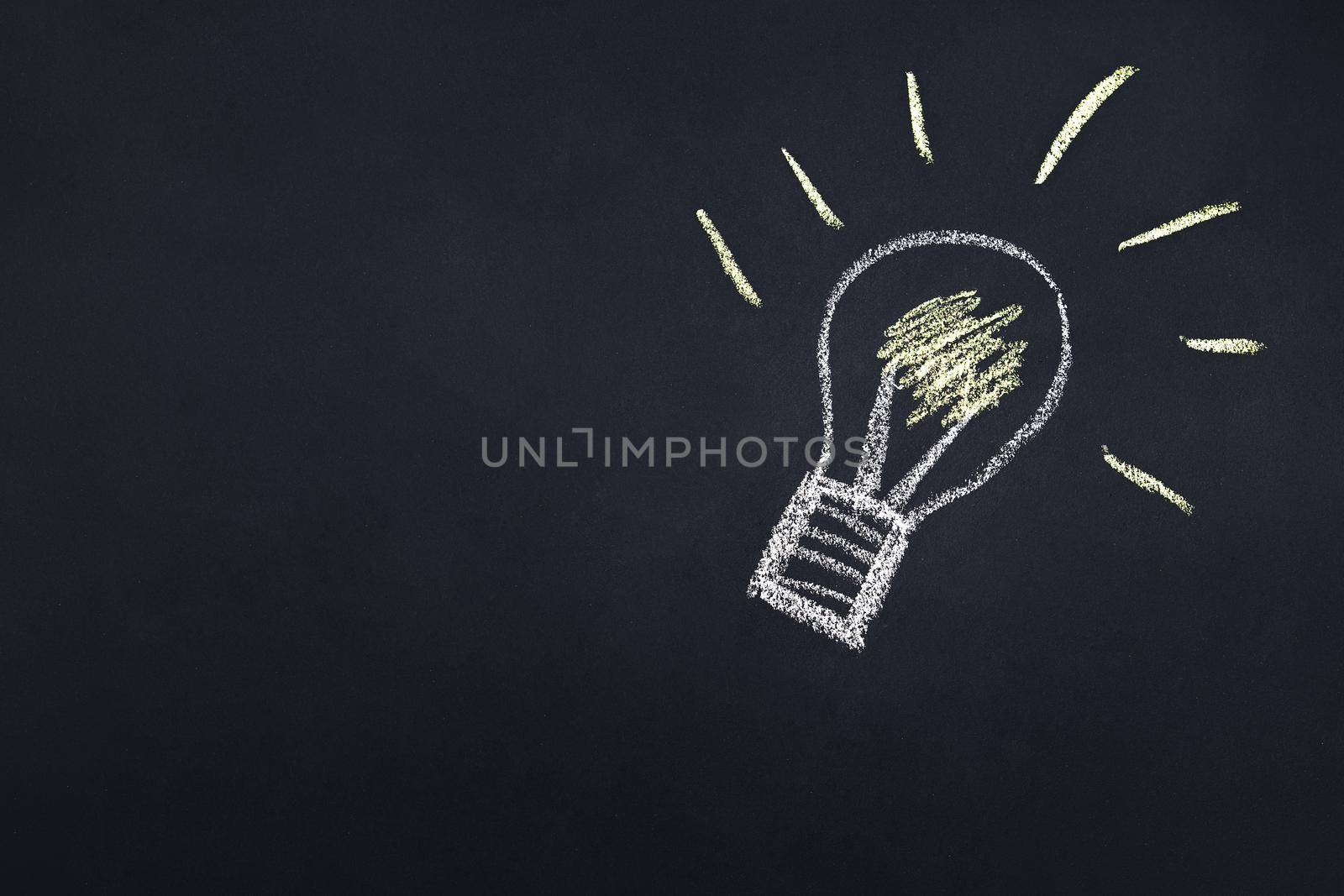 light bulb drawn with chalk on a blackboard