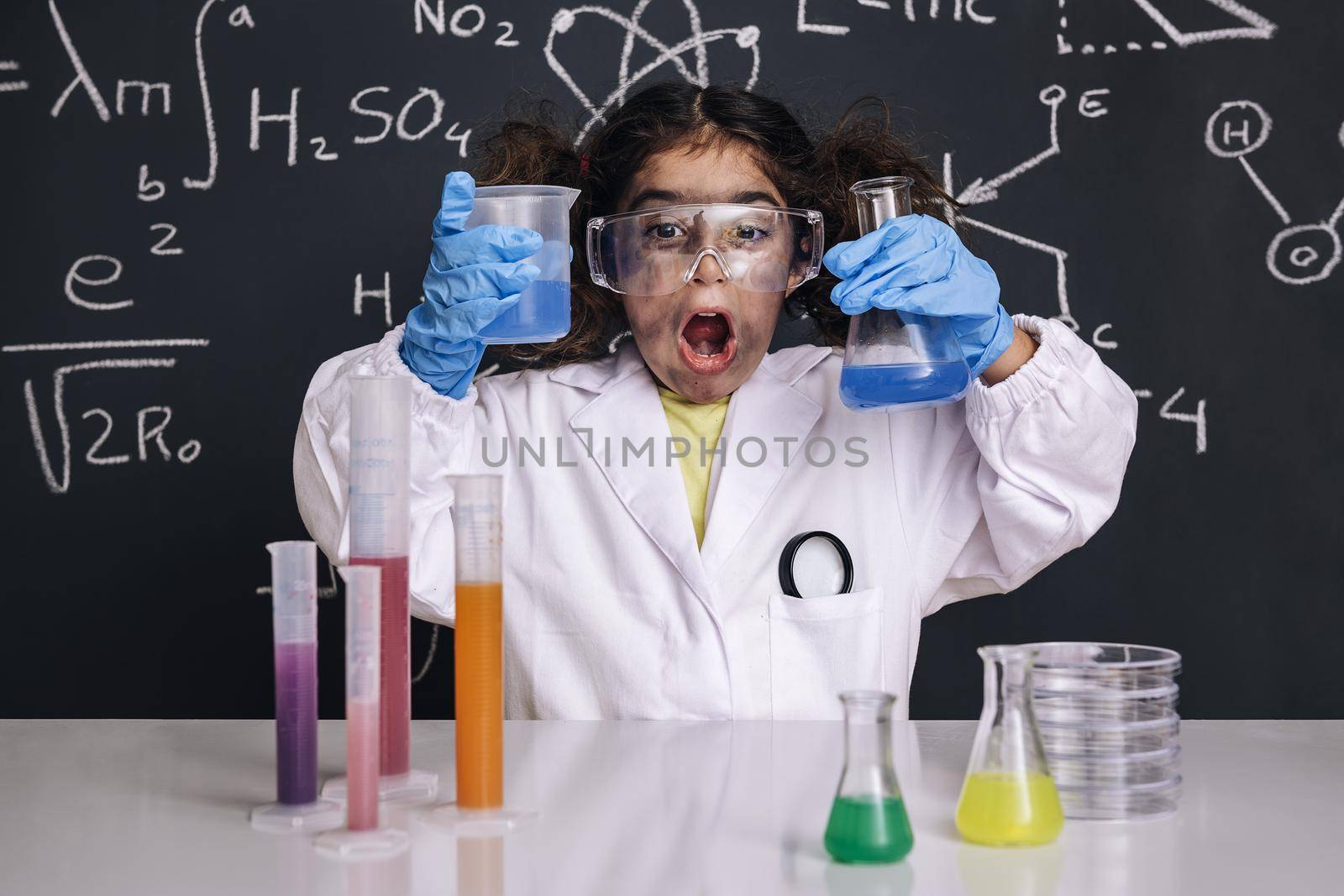 funny scientist child with goggles in lab coat by raulmelldo