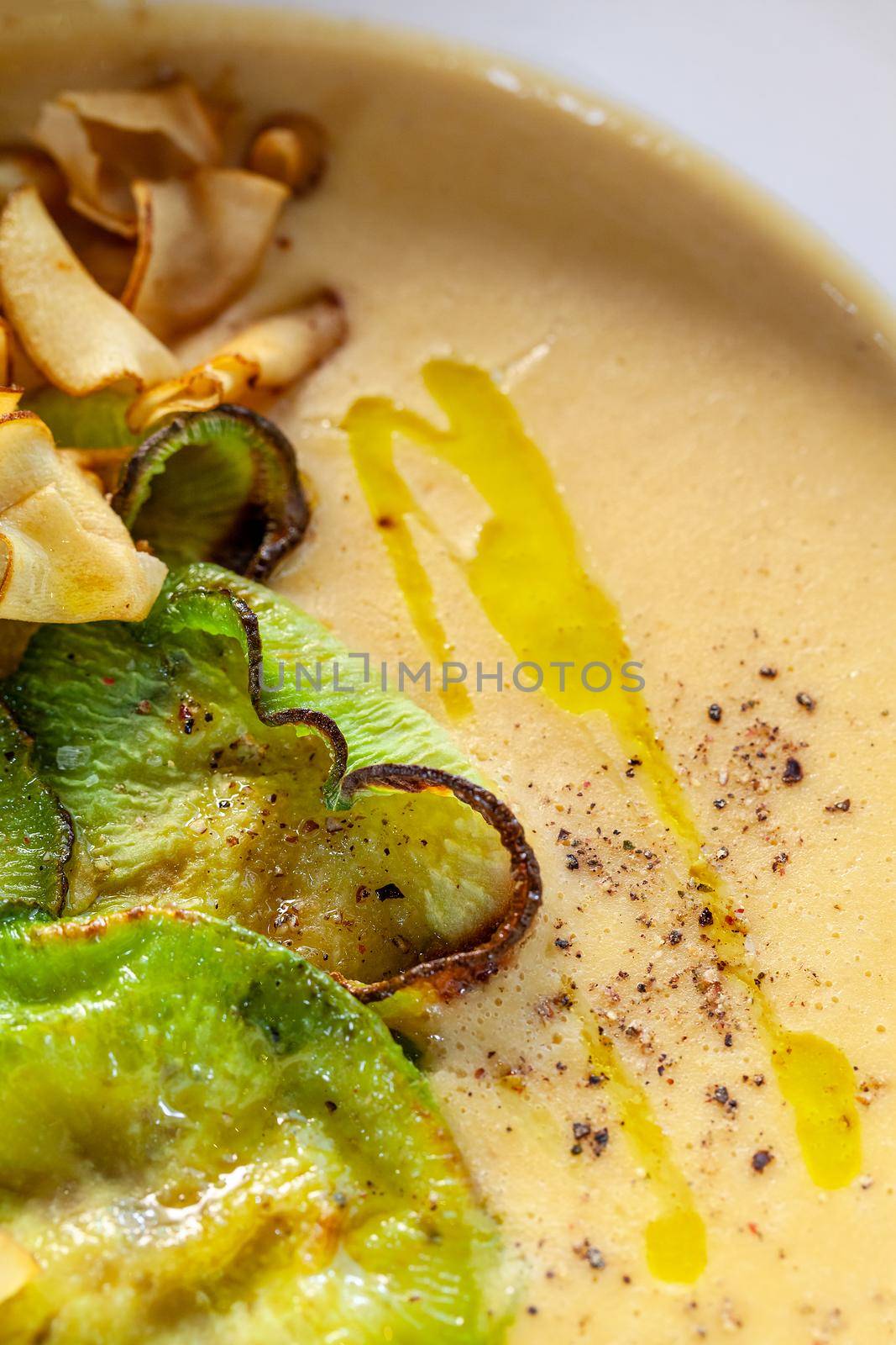 Macro shot of a tasty cream soup with vegetables, top view. Gourmet meal, restaurant serving. Cooking concept.