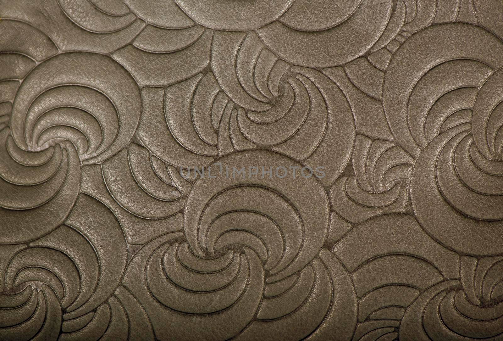 Texture of gray genuine leather with embossed floral trend pattern close-up, color, for wallpaper or banner design