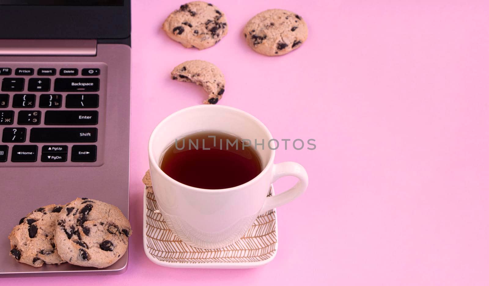 home office laptop chocolate chip cookies and tea cup. High quality photo