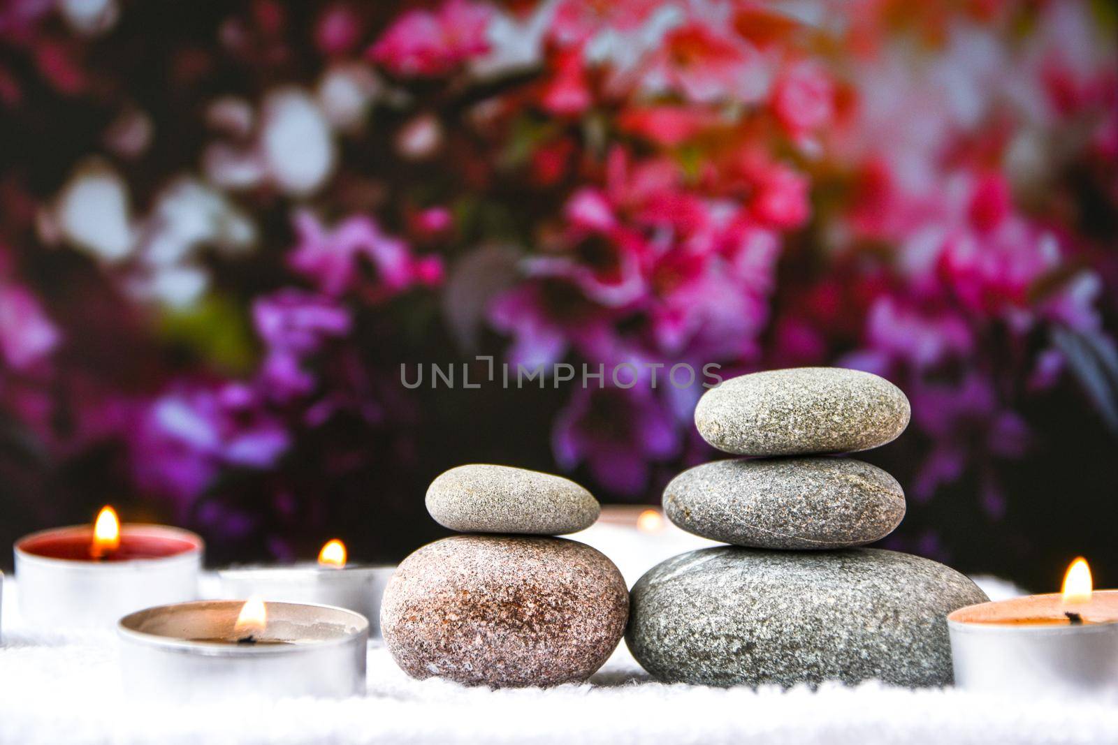 Zen concept, spa pebbles stones and burning aroma candles on blurred background, Treatment aromatherapy and massage, copy space for text