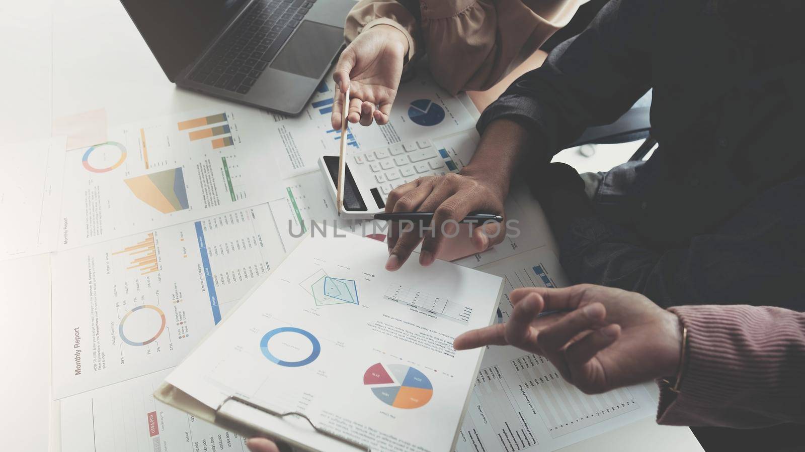 Business People Meeting using laptop computer, calculator,notebook,stock market chart paper for analysis Plans to improve quality next month. Conference Discussion Corporate Concept.