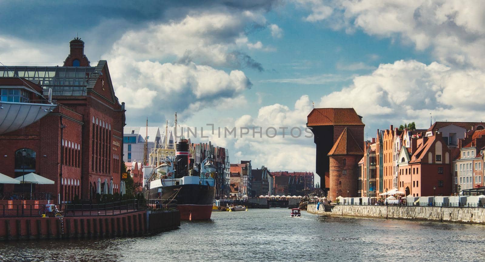 Wide panorama view of the river in Gdansk showing the old town crane