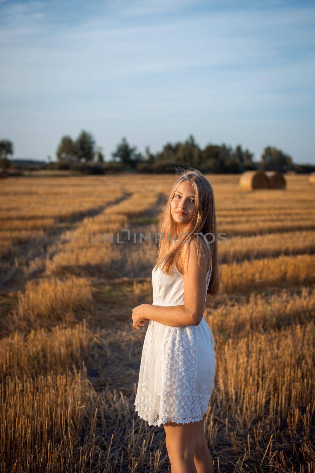 Portrait of a young attractive girl on nature in the evening