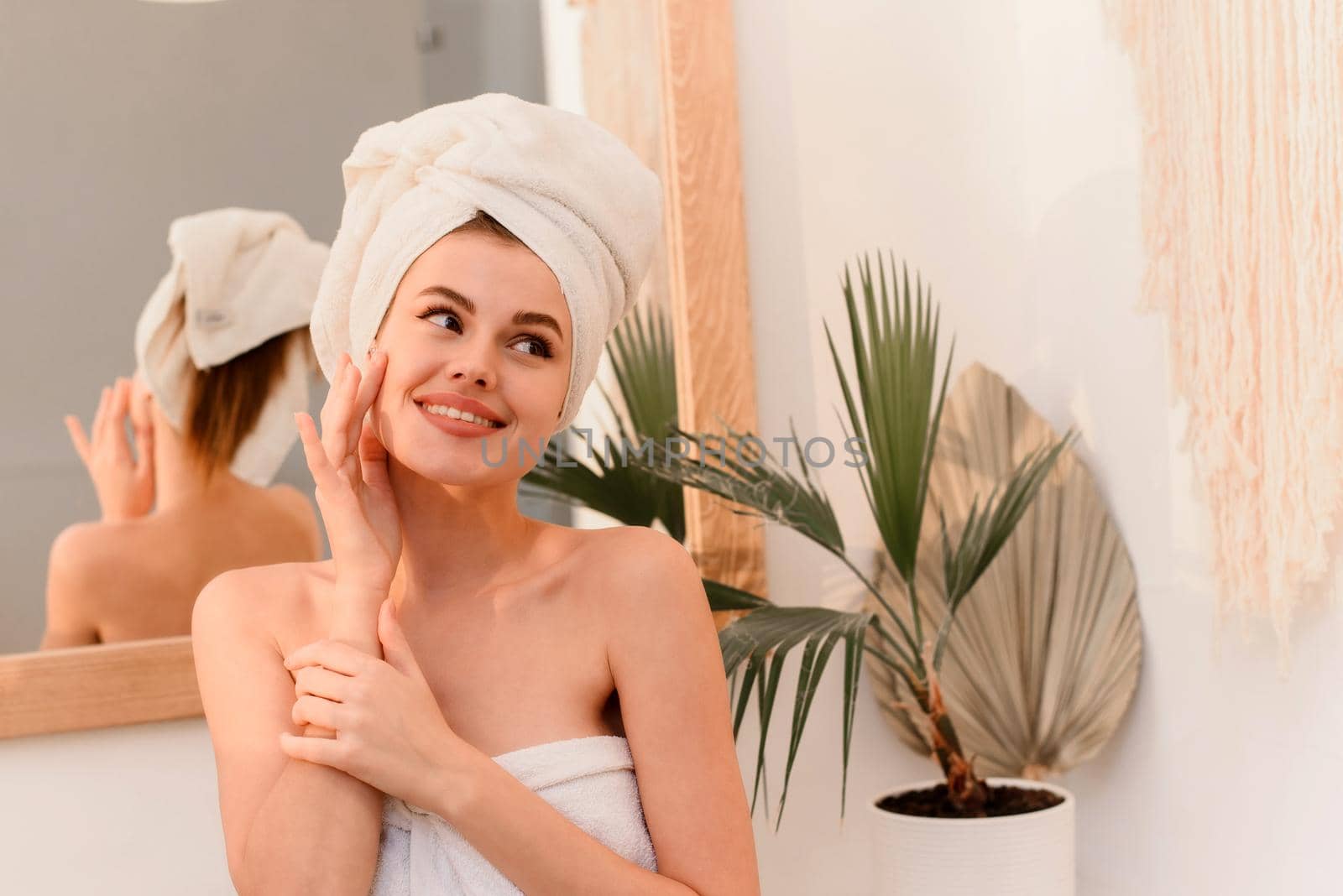 Young smiling woman smiling after spa treatments in bathroom.
