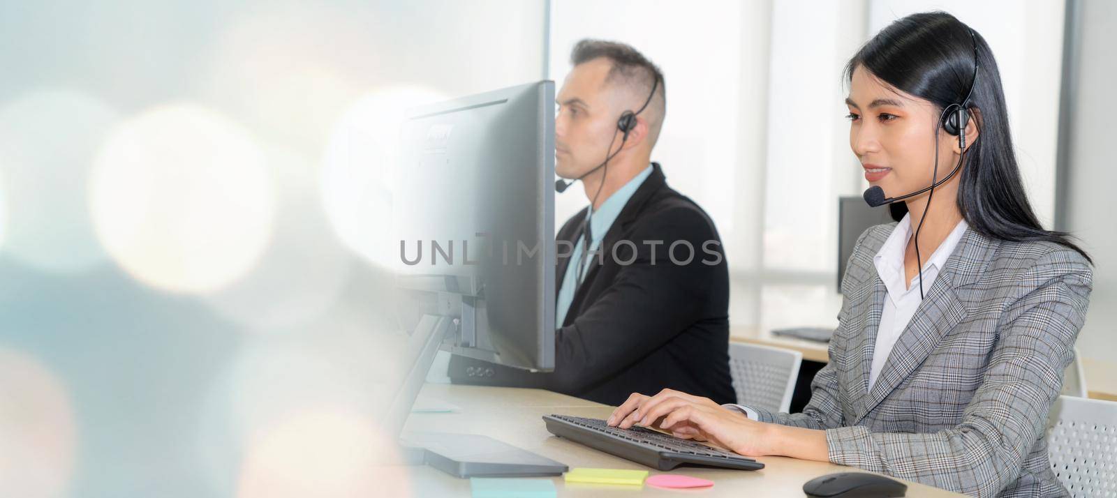 Business people wearing headset working in office broaden view by biancoblue