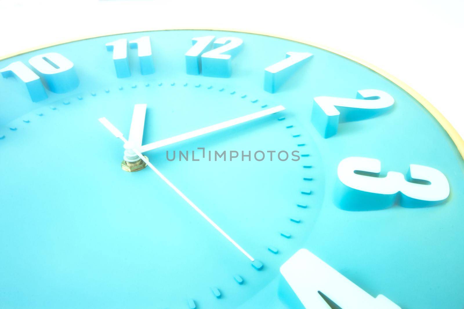 Close up of a blue clock face with 3D numbers and second hand