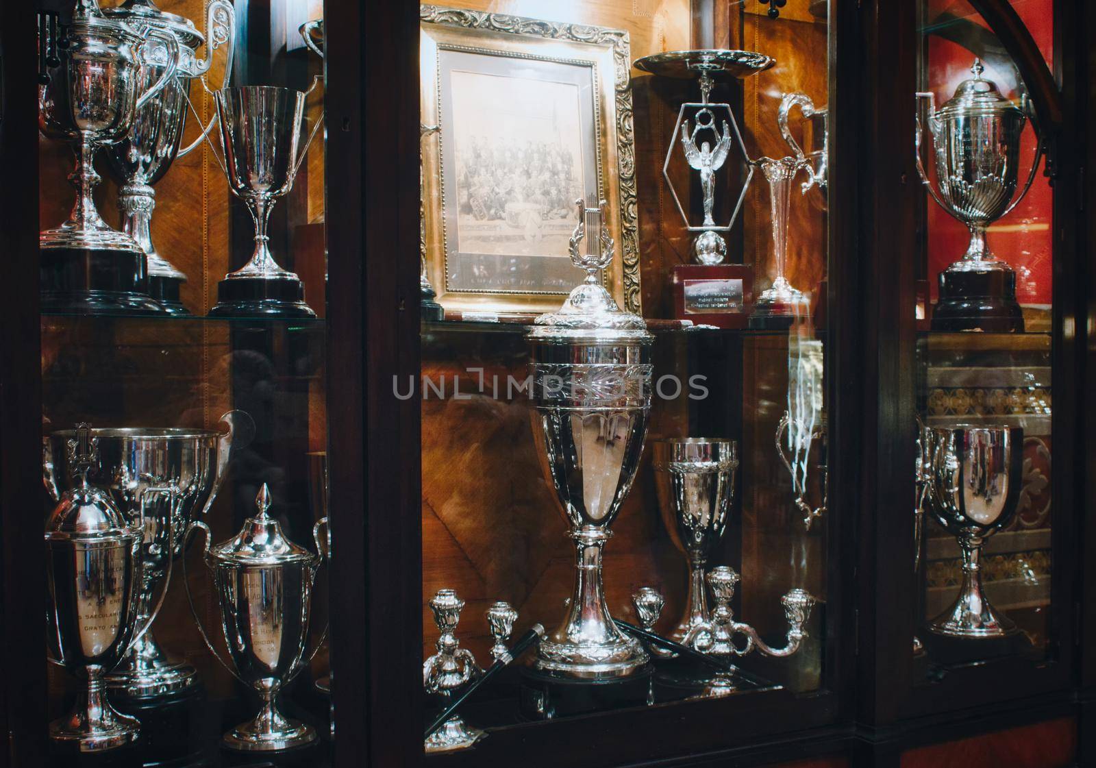 Rabat / Malta - December 30 2019: Shiny trophies in an illuminated classic style trophy cabinet