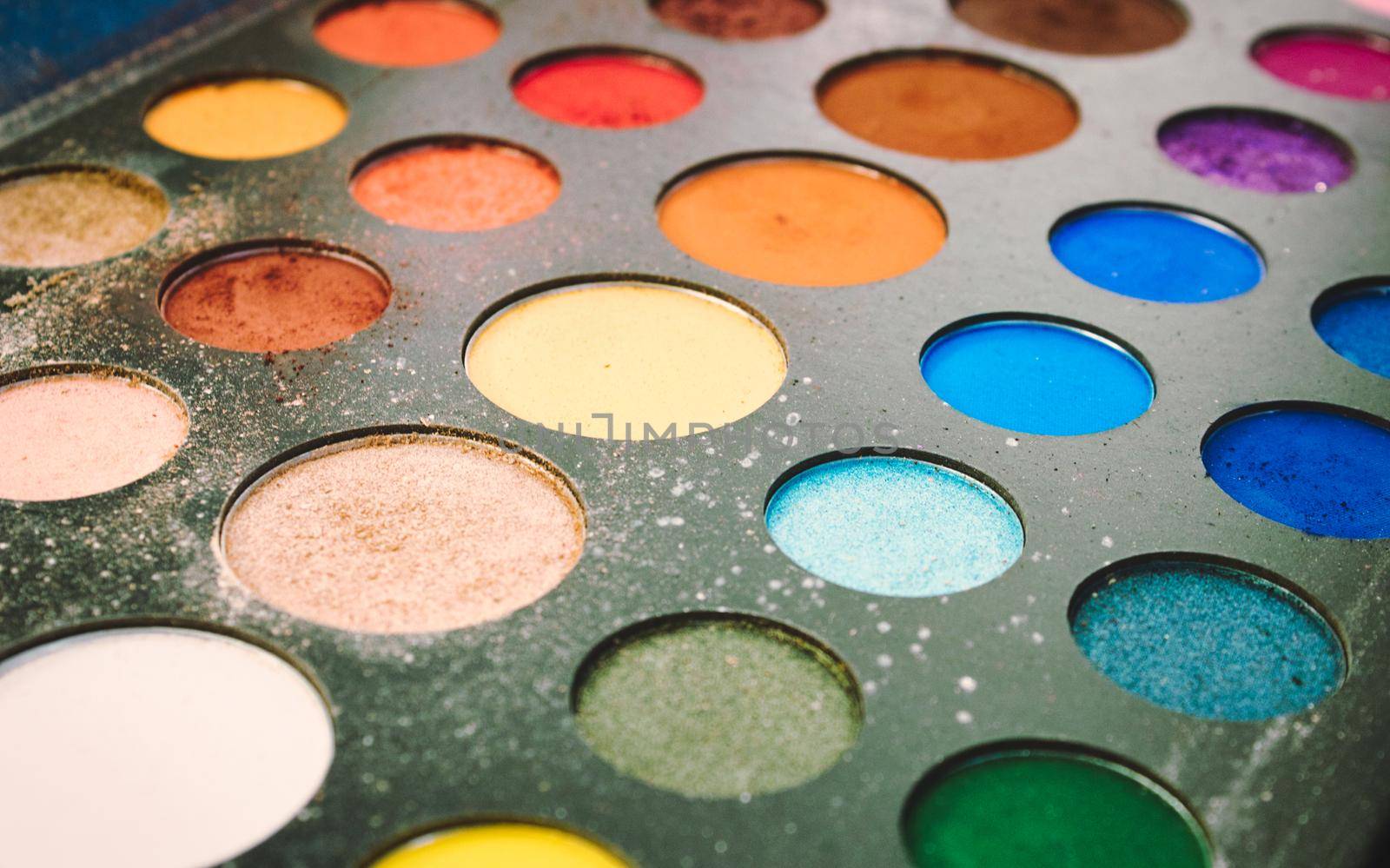Closeup of multi-colored cosmetic powder for professional makeup artist by tennesseewitney