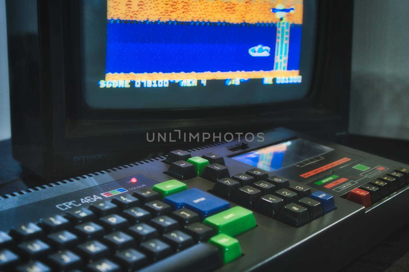Mosta / Malta - July 3 2019: Amstrad CPC 464 keyboard and monitor displaying a retro computer game by tennesseewitney