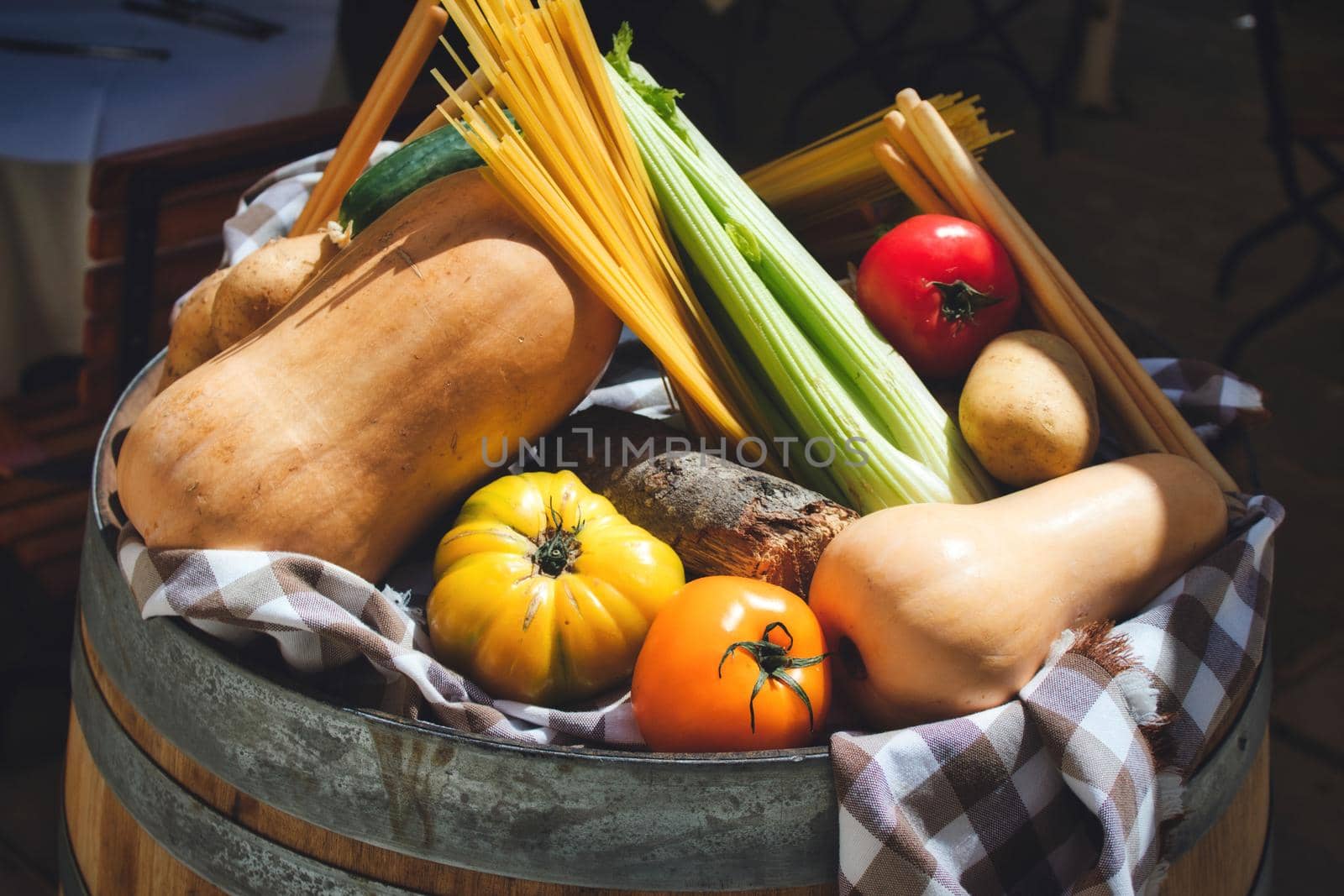 A selection of healthy winter vegetables on display on top of a barrel