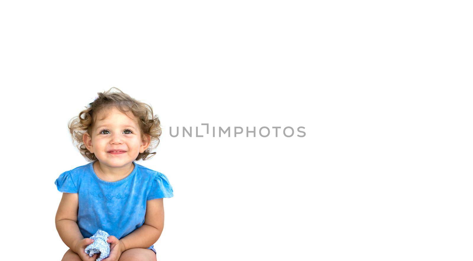 Cute smiling little girl looking thoughtful isolated against a pure white background