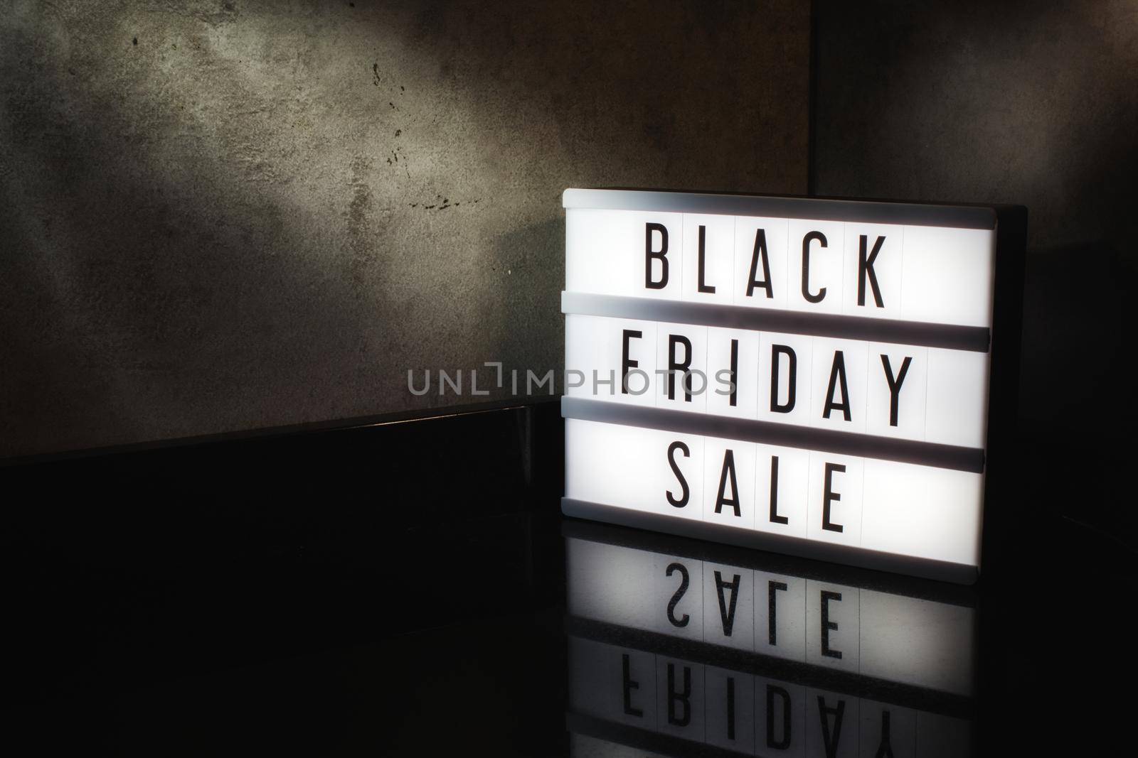 Black Friday Sale message on a light box with a dark cinematic feel