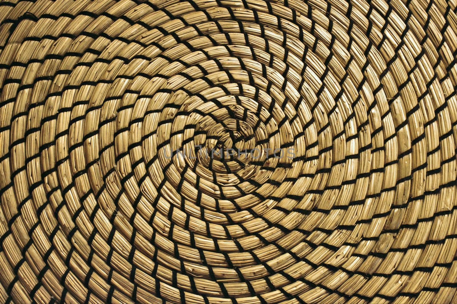 Close-up of circular straw mat with a spiral pattern