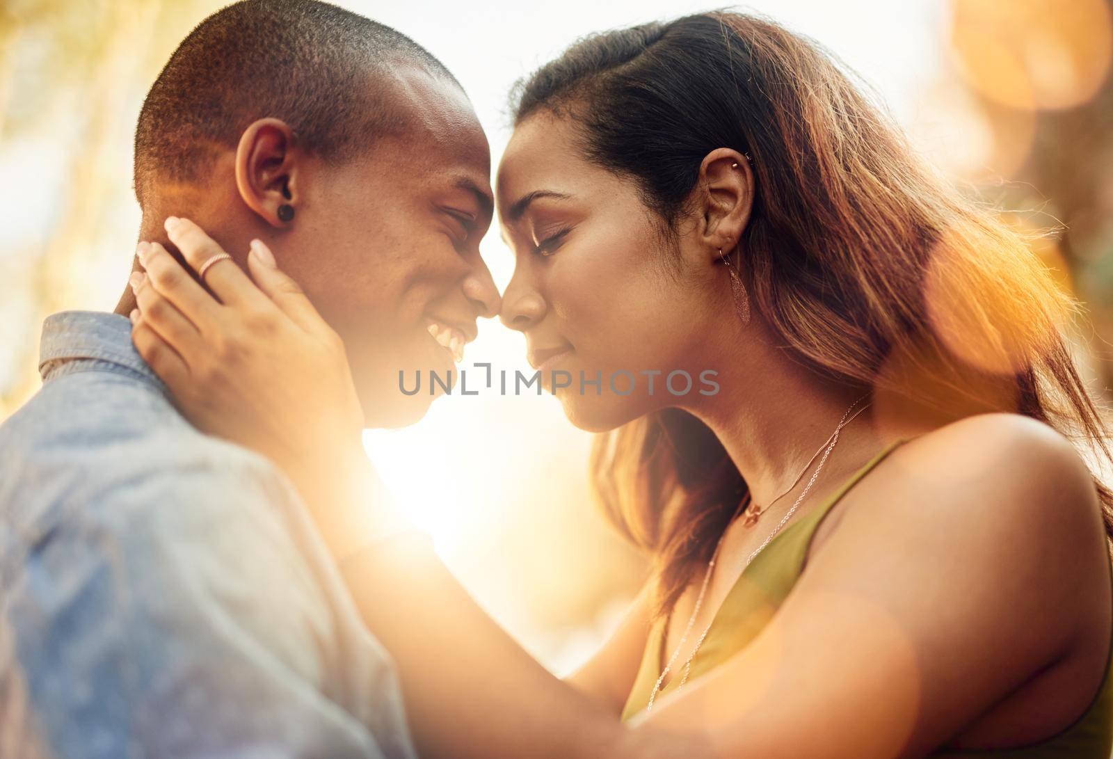 Theyve got that soulmate kinda love. Shot of an affectionate young couple sharing a tender moment outdoors. by YuriArcurs