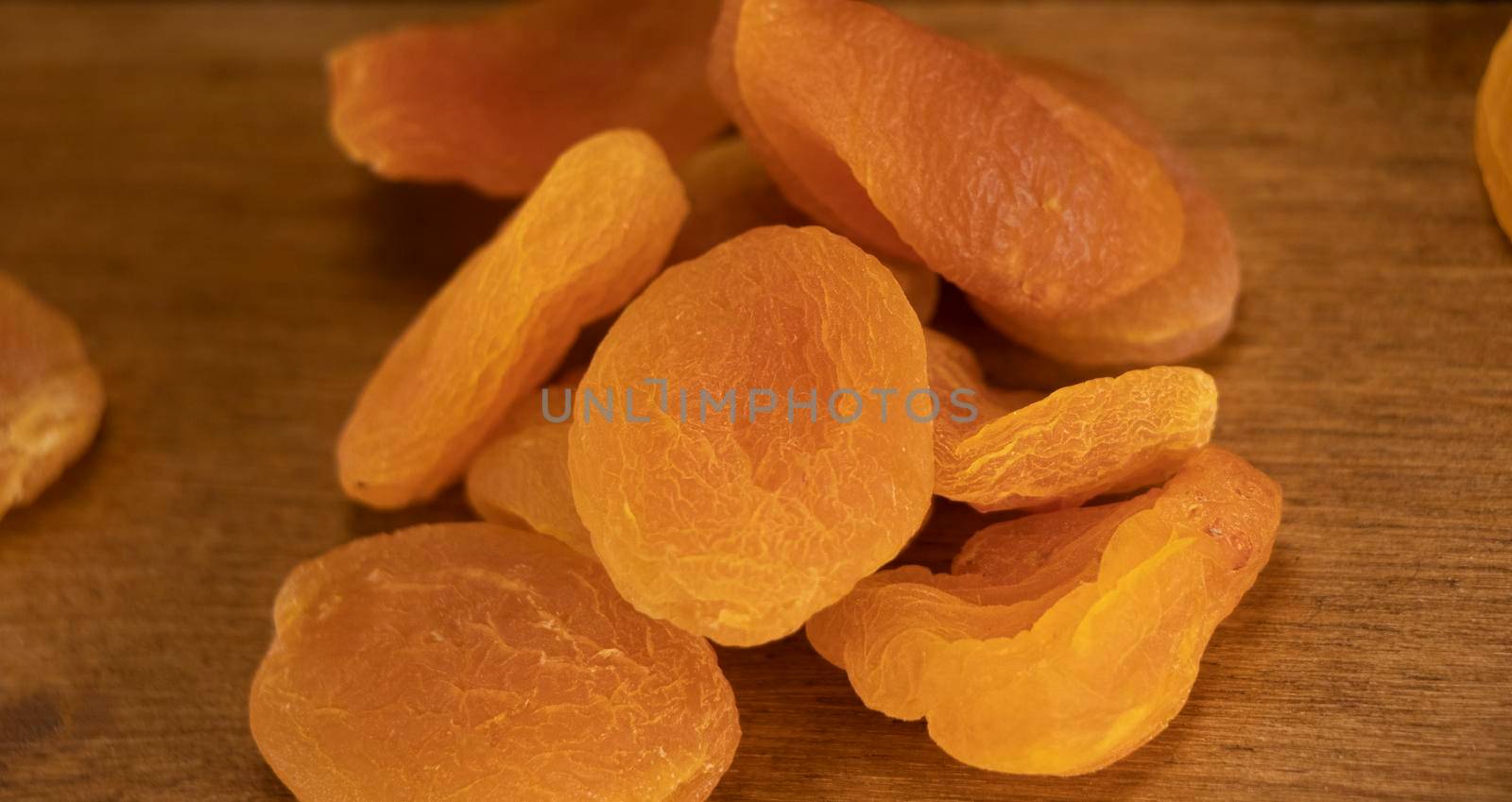 Orange dried apricots. Dried apricot, dried fruits are scattered on the table.dietary dessert. Eco product for vegetarians. High quality photo.