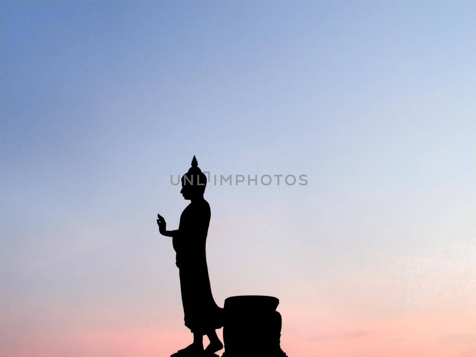 Big Buddha statue silhouette vanila sky blue pink orange shade at sunset beautiful background