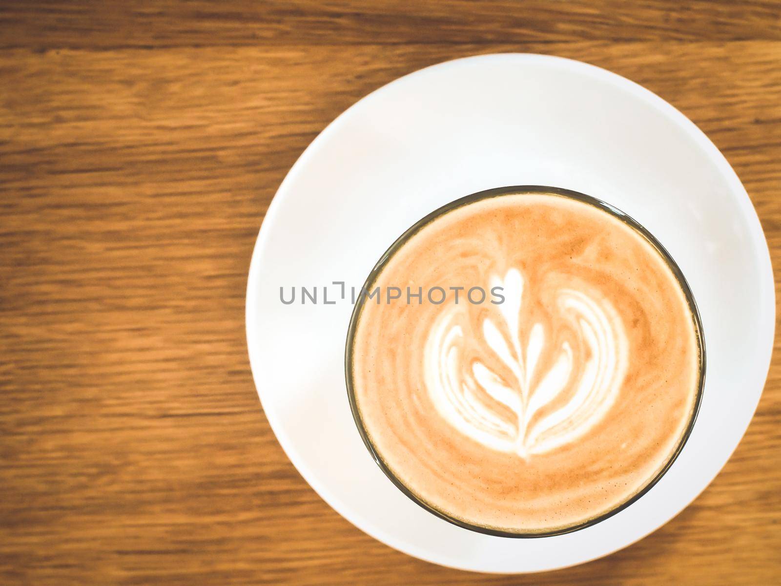 hot milk coffee on white glass plate by Petrichor