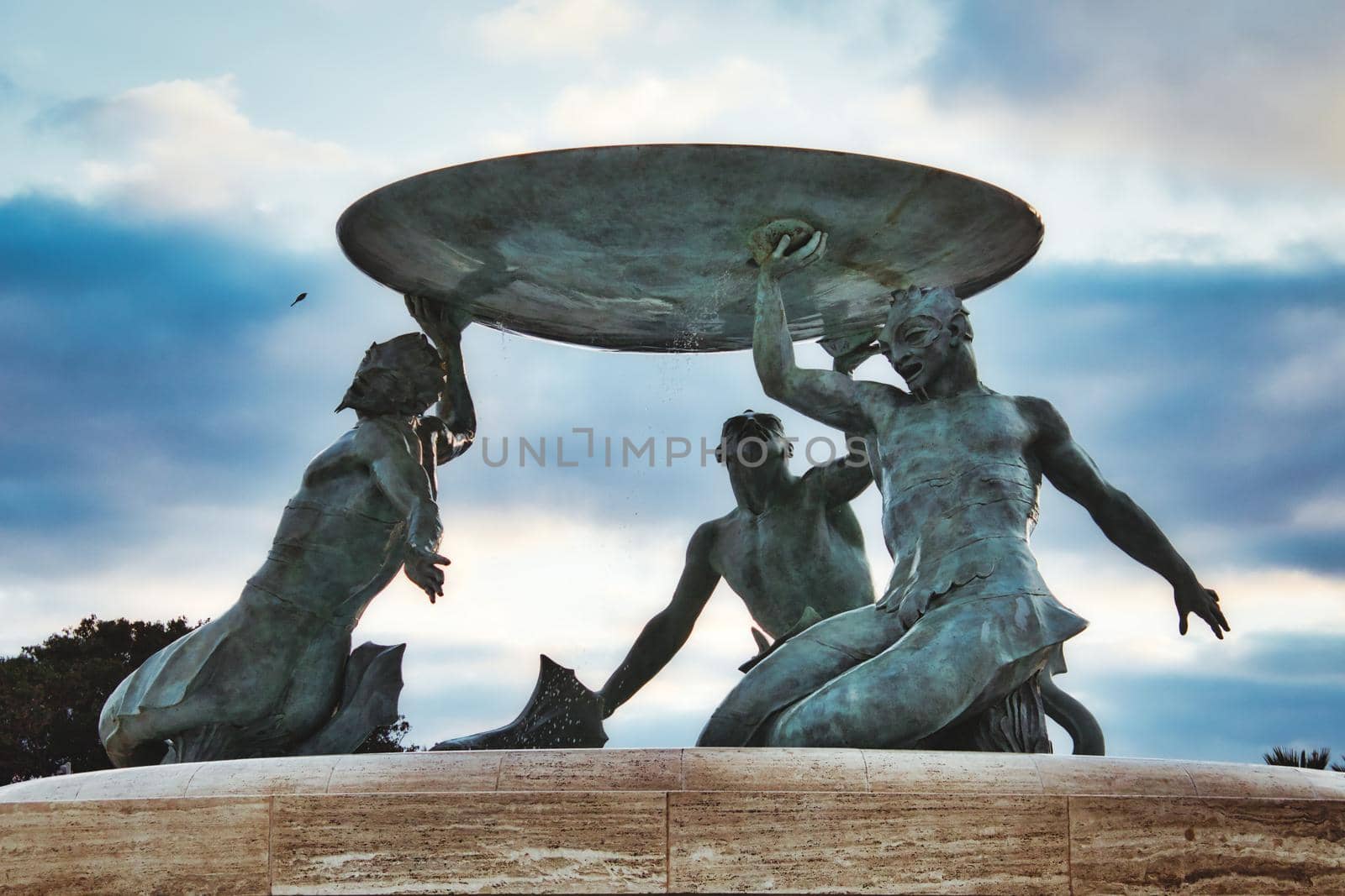 Valletta, Malta - January 01 2020: Triton's fountain in bronze at the city gate of Valletta, Malta, viewed from below by tennesseewitney