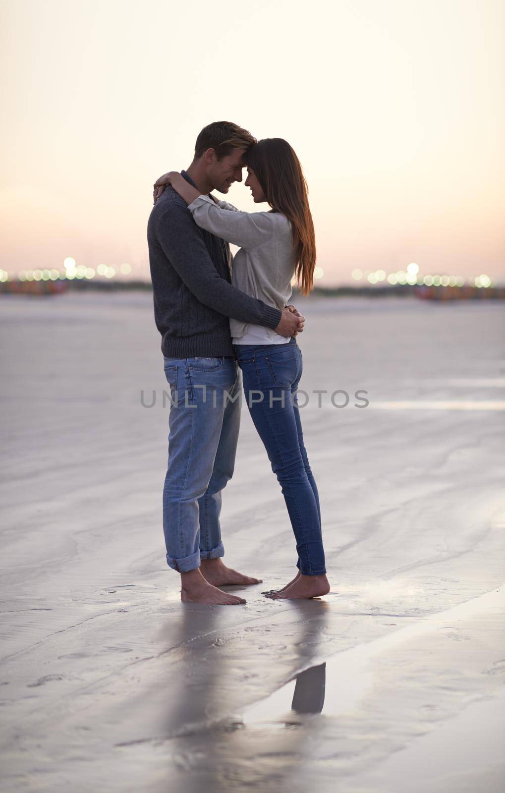 A young couple enjoying a romantic moment together at the beach.